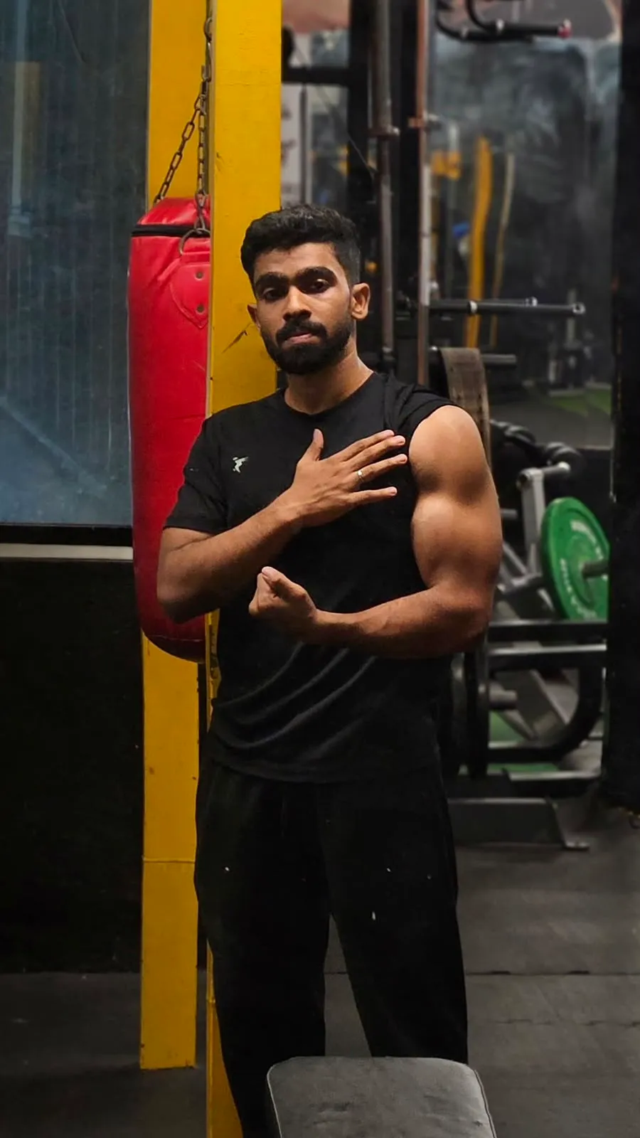 Akhil flexing after a workout